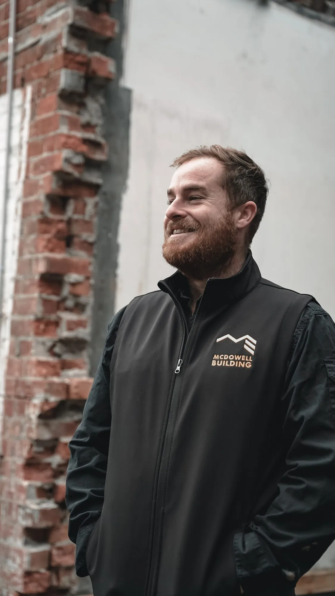 A member of the McDowell team outside a brick building in Melbourne's inner north