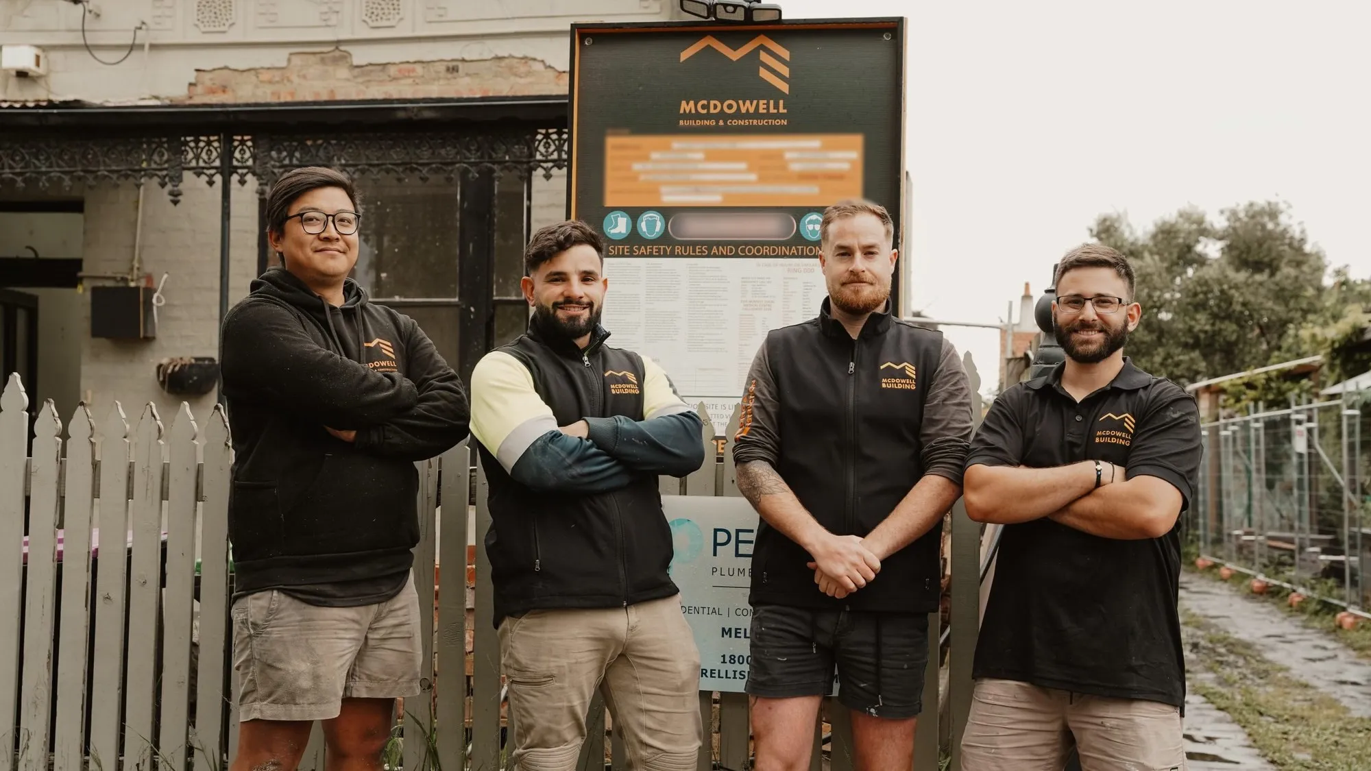 The McDowell team beside their site signage